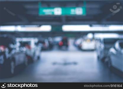 Blurry of car parking lots at department store. Abstract and transportation concept. Dark and low key tone