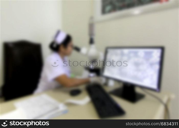 blurry picture nurse working with a microscope in hospital