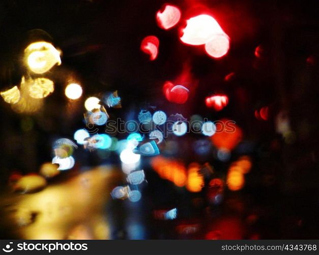 Blurry specular street lights at night.