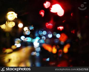 Blurry specular street lights at night.