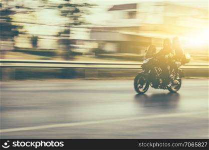 Blurry subject motorcycle driving on road