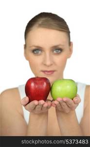 Blurry woman showing apples on white background