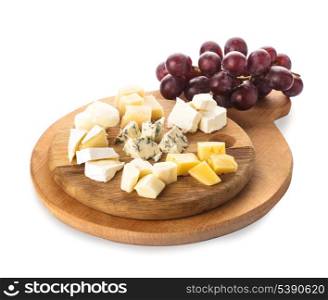 Board with pieces of various types of cheese, and grape, isolated on white