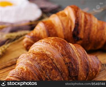 Board with tasty croissants and pastries on table