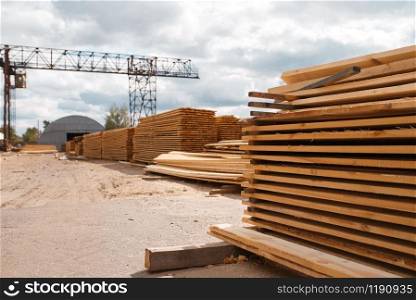 Boards on timber mill warehouse outdoor, nobody, lumber industry, carpentry. Wood processing on factory, forest sawing in lumberyard, sawmill. Boards on timber mill warehouse outdoor, nobody