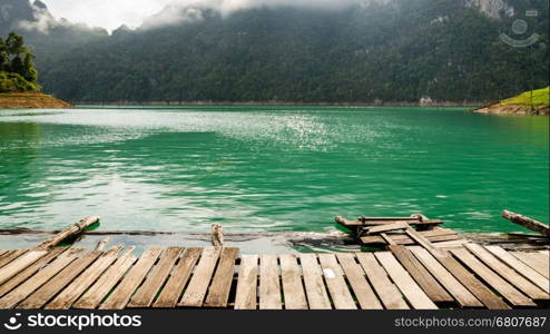 Boardwalk high mountains and green water in morning, Front view of the bungalow at Ratchaprapha Dam, Khao Sok National Park, Surat Thani Province, Thailand