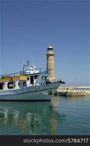 boat and lighthouse of rethimno in the island of crete, greece