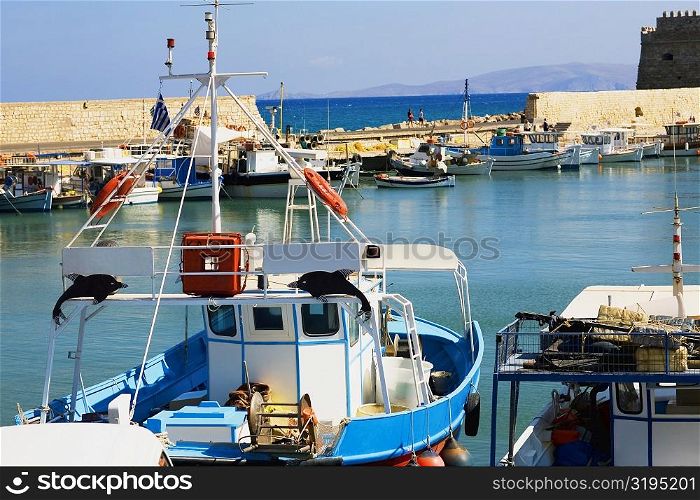 Boat at a harbor with a fortress in the background, Venetian Fortress, Heraklion Harbour, Heraklion, Crete, Greece