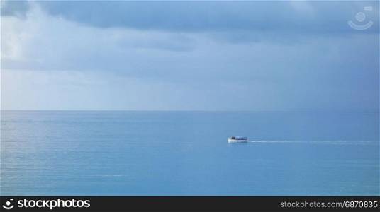 Boat at the sea with rainy clouds