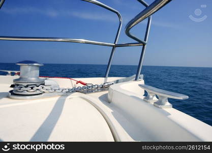 boat bow sailing on blue sea with anchor chain and winch detail