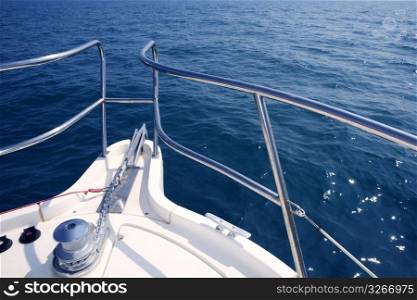 boat bow sailing on blue sea with anchor chain and winch detail