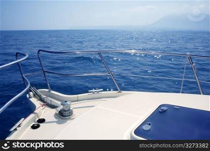 boat bow sailing on blue sea with anchor chain and winch detail