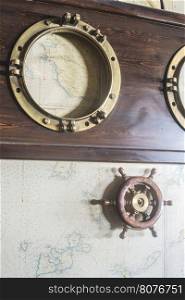 Boat details on wall. Vintage map and rudder. Greece