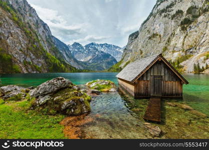 Boat dock hangar on Obersee mountain lake in Alps. Bavaria, Germany