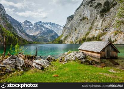 Boat dock hangar on Obersee mountain lake in Alps. Bavaria, Germany