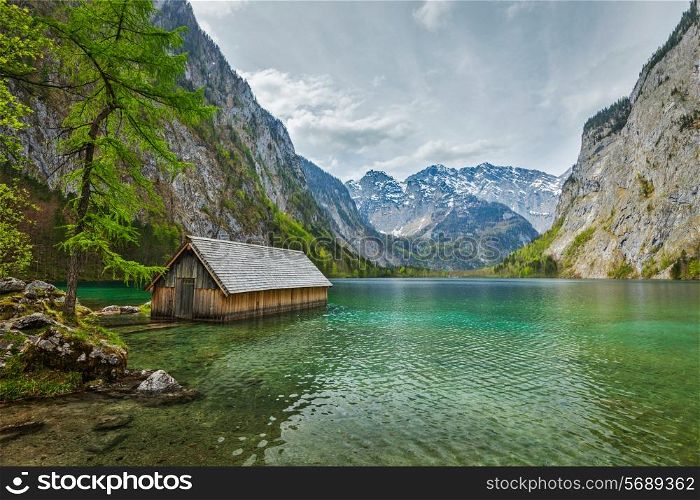 Boat dock hangar on Obersee mountain lake in Alps. Bavaria, Germany