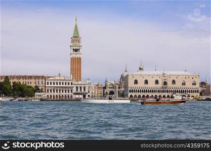 Boat docked near a tower, Bell Tower, St. Mark&acute;s Square, Venice, Italy