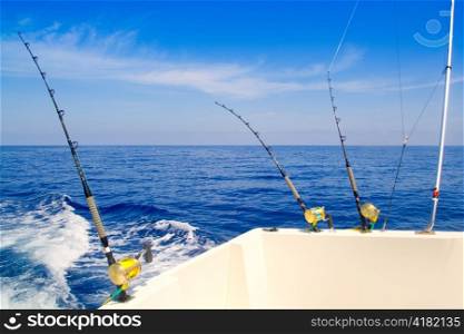 boat fishing trolling in deep blue sea with rods and reels
