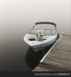 Boat moored at dock, Lake Of The Woods, Ontario, Canada