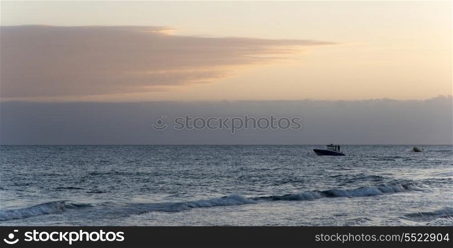 Boat moving in the sea at dusk, Bay Islands, Honduras