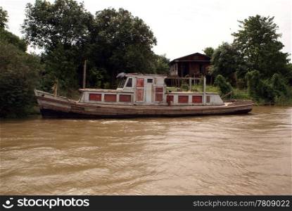Boat near house on the river, Mandalay, Myanmar