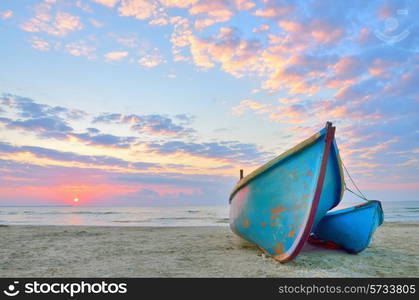 Boat on beautiful beach in sunrise on Black Sea