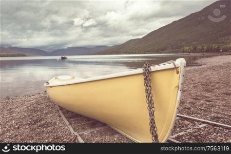 Boat on lake in mountains. Autumn season.