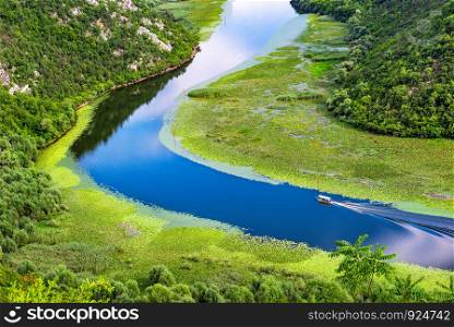 Boat on river in mountains of Montenegro, view from above. Boat on river in mountains