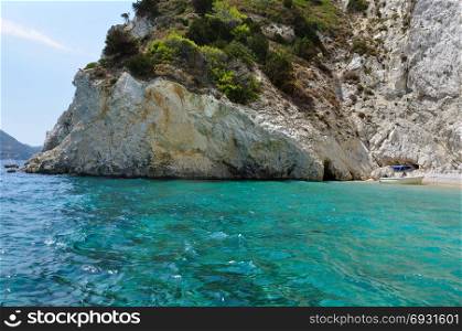 Boat on rocky beach. Summertime in Zakynthos, Greece.