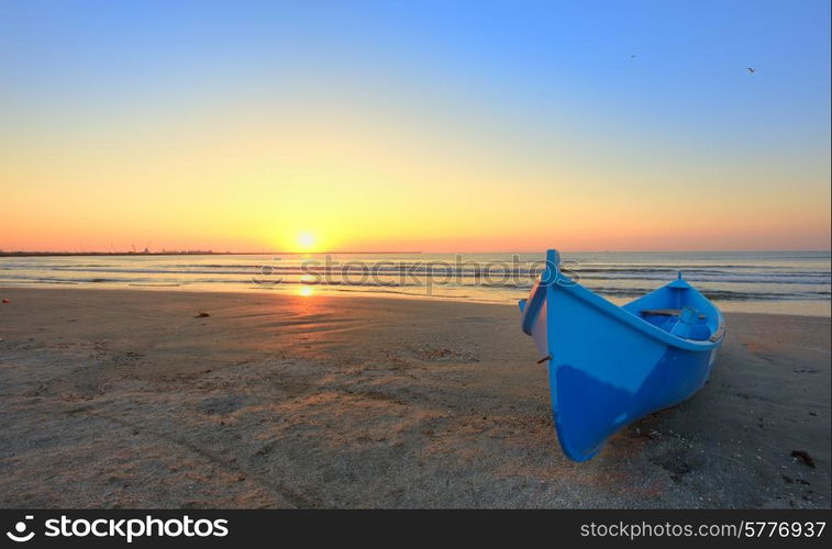 Boat on the beach at sunrise time