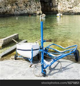 Boat on the trolley for launching on the water. The Inland Sea is a lagoon of seawater on the island of Gozo linked to the Mediterranean Sea through a narrow natural arch.