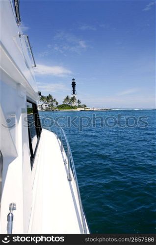 Boat side view and Florida Lighthouse blue sea