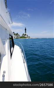 Boat side view and Florida Lighthouse blue sea