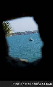 Boat viewed through a hole, Matanzas Bay, St. Augustine, Florida, USA