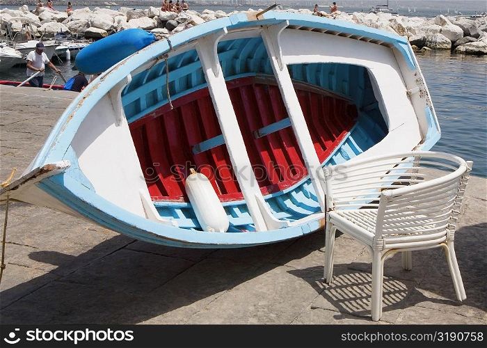 Boat with a chair at the coast, Bay of Naples, Naples, Naples Province, Campania, Italy