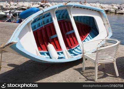 Boat with a chair at the coast, Bay of Naples, Naples, Naples Province, Campania, Italy
