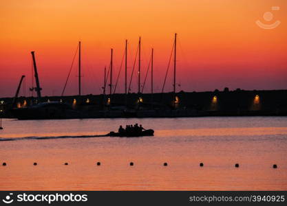 Boat with people in the small port of Marciana, Elba Island, Italy on the sunset