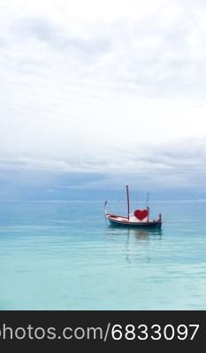 boat with red heart in the ocean