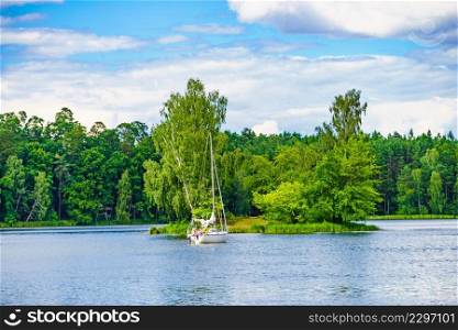 Boat yacht on lake during summer. Tuchola national park in Poland. Yachting, holidays concept.. Yacht on lake in Tuchola Forests, Poland.