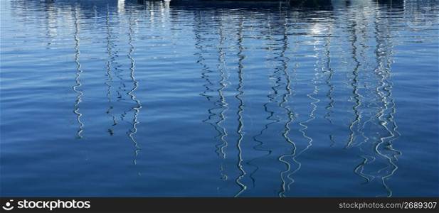 Boats abstract reflexion over blue mediterranean saltwater
