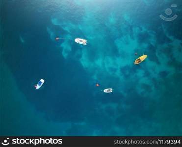 Boats. Aerial view of boats in sea. Beautiful summer seascape with ships, clear azure water at sunny day. Top view.
