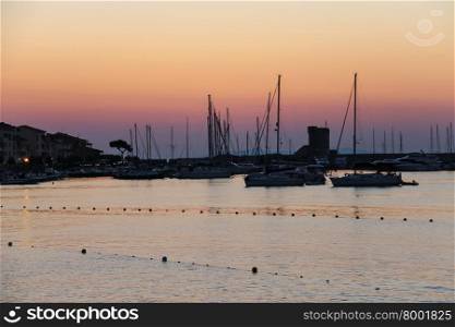Boats anchored in the small port of Marciana, Elba Island, Italy on the sunset