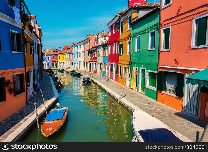 Boats and colored houses in summer Burano, Italy. Houses in summer Burano