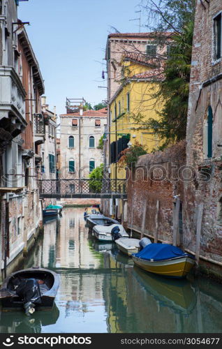 Boats and gondolas on Grand Canal of Venice, Italy. Moored gondolas in Venice.. Venice canal scene in Italy