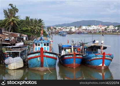 Boats and palm tree in Nha Trang, Vietnam