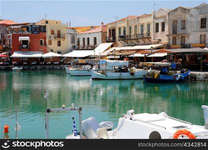 Boats and restaurants in the old Venetain port of Rethymno on Crete island in Greece