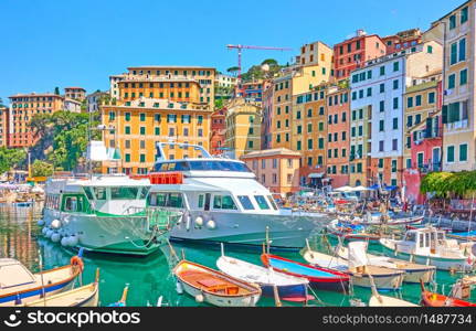 Boats and ships in the port of Camogli town on sunny summer day, Genoa, Italy