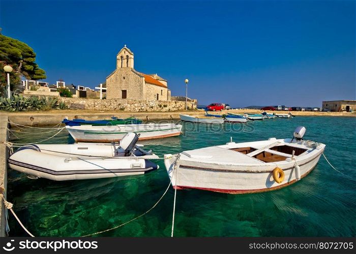 Boats and stone church in Savar, island of Dugi Otok, Croatia