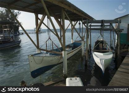 Boats at a dock, Cayman Cay, Utila Island, Bay Islands, Honduras