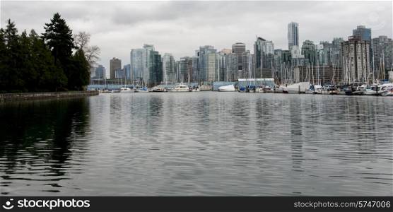 Boats at harbor, Coal Harbour, with Vancouver city skyline, British Columbia, Canada